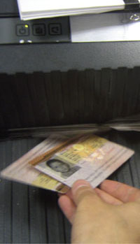 Partial Photo of ID Cards Entering Shredder